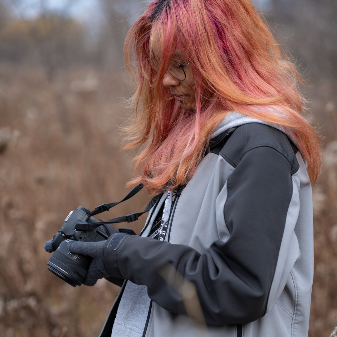 Pink haired girl holding camera