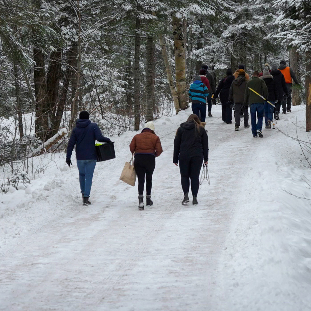 Group of people walking down a snowy road